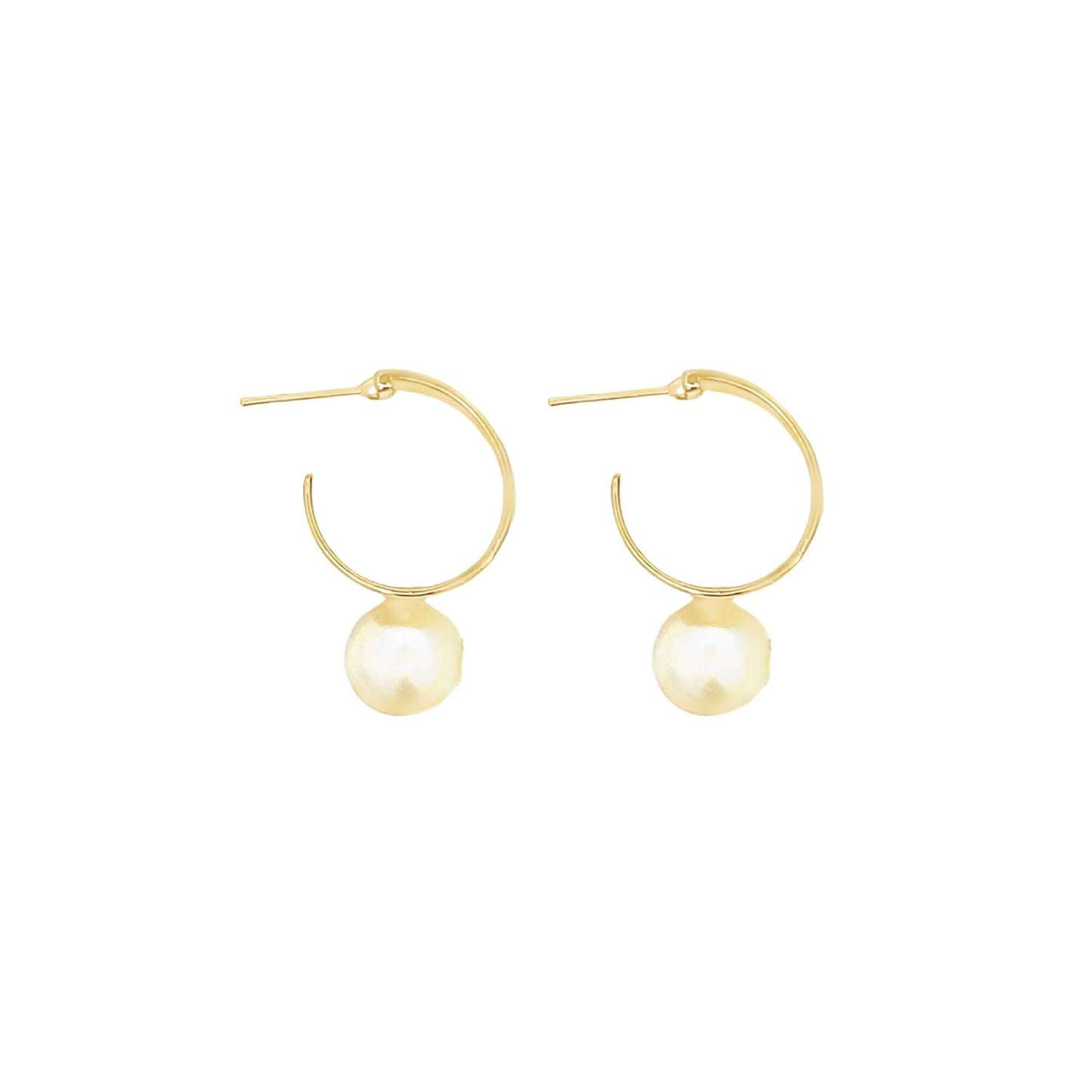 A pair of gold hoop earrings features hanging pearl charms against a plain white background.