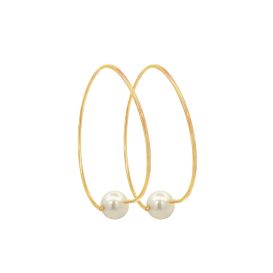 A pair of elegant gold hoop earrings features a single lustrous pearl resting at the bottom of each loop.