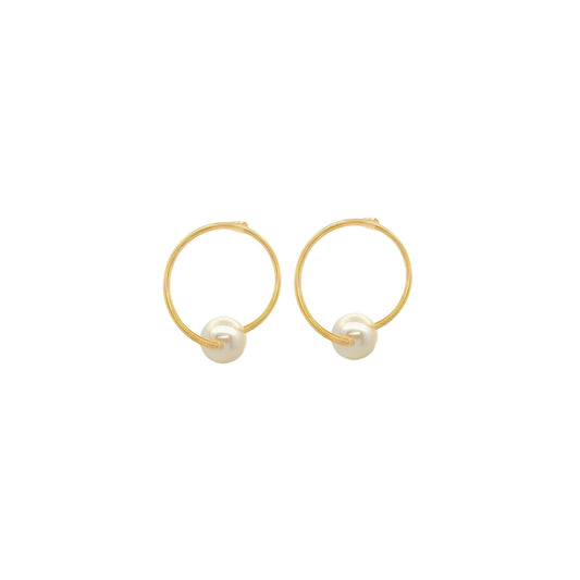 A pair of elegant gold hoop earrings feature lustrous white pearls nestled at the base against a clean white background.
