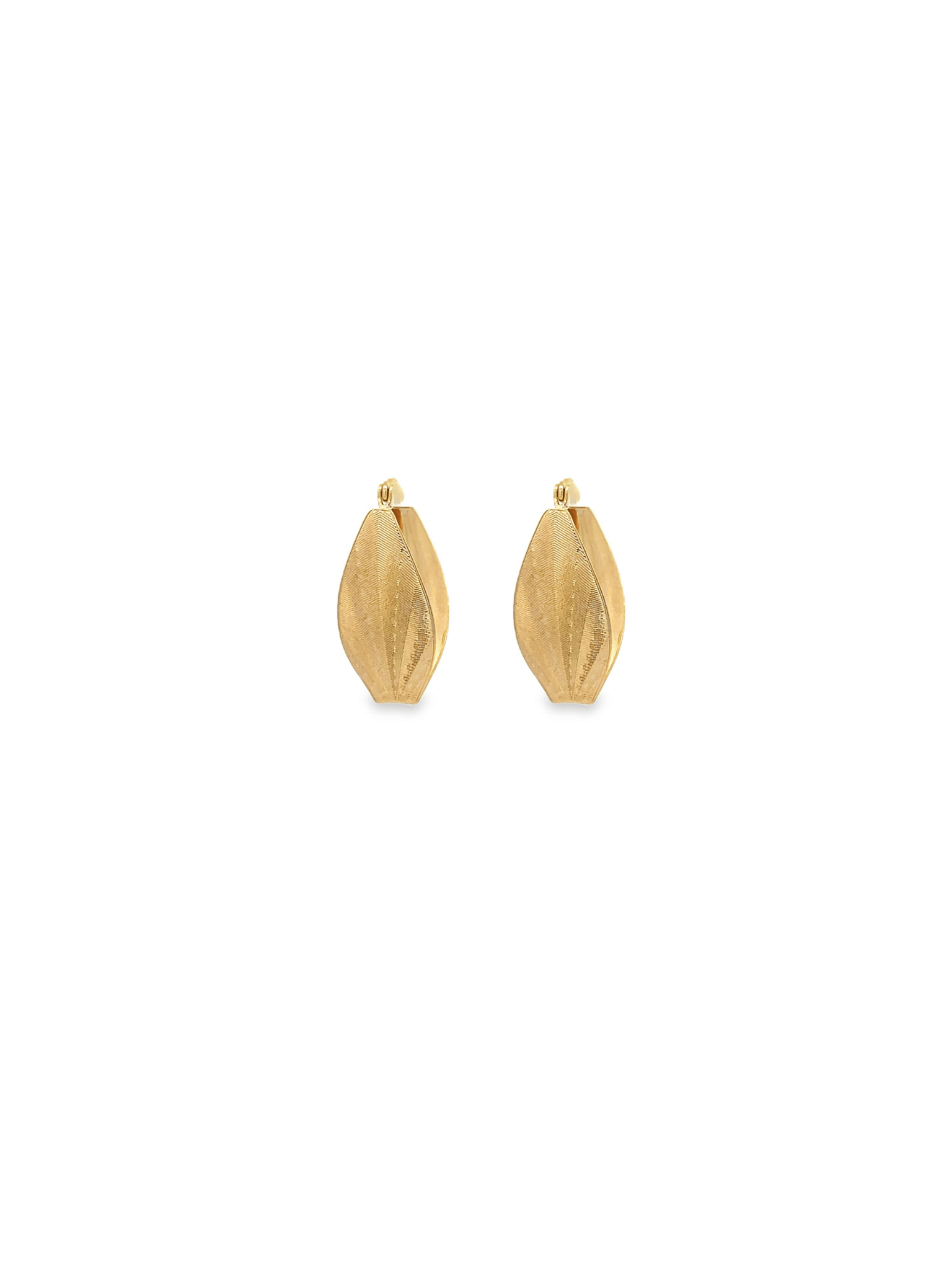 A pair of textured gold huggie hoop earrings with a leaf-like design rests against a clean white background.