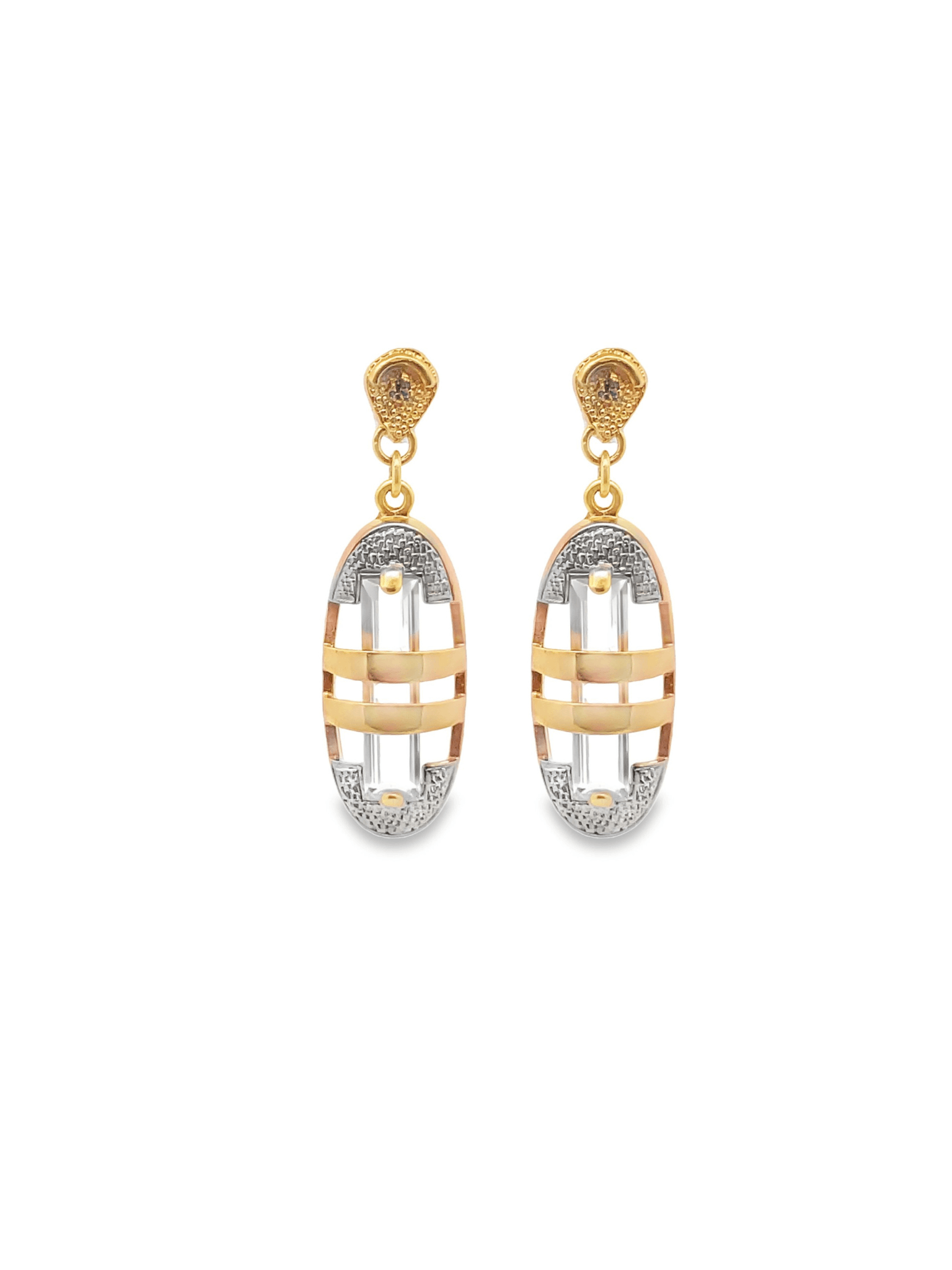 A pair of elegant two-tone gold drop earrings featuring intricate oval frames with central crystal baguettes hangs against a clean white background.