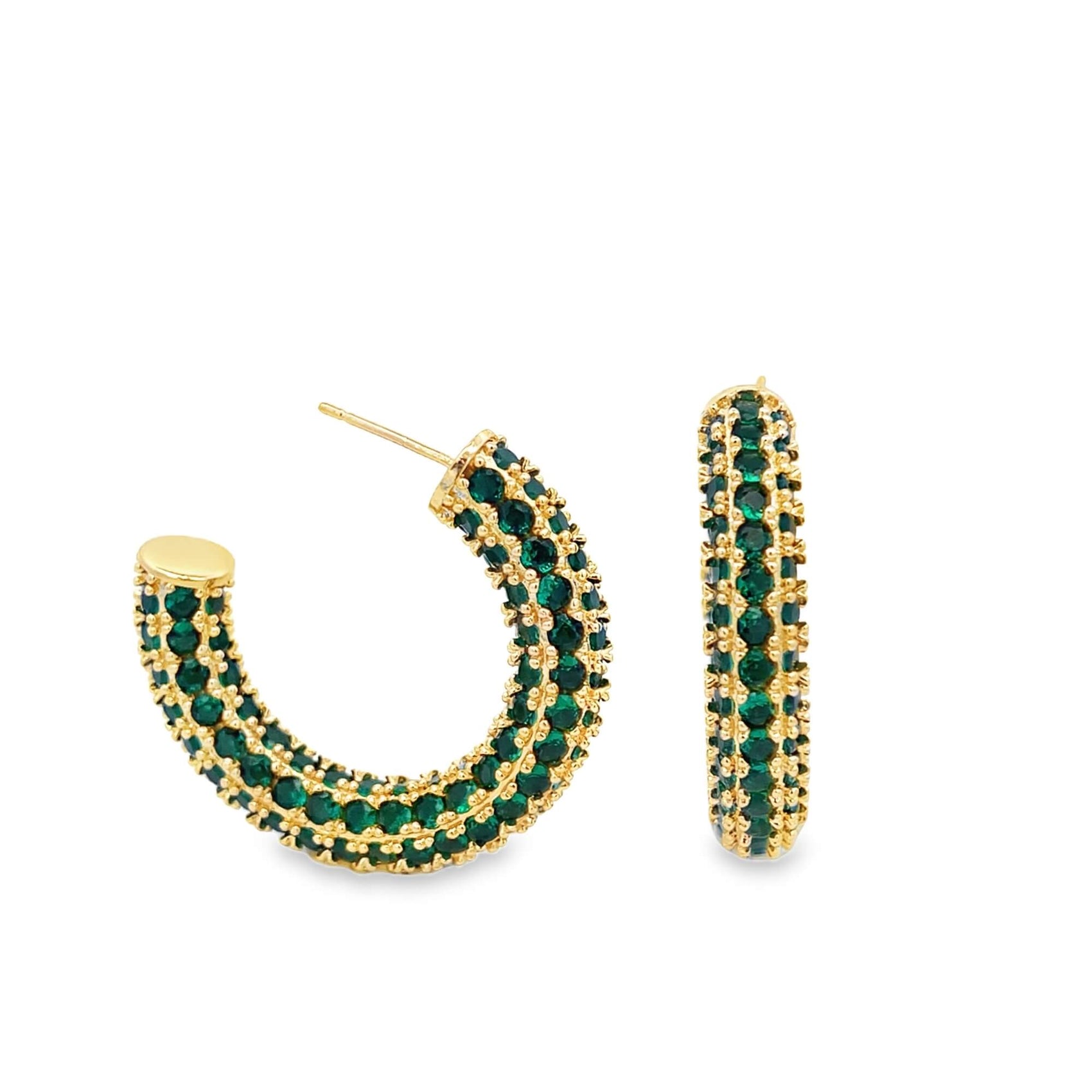 A pair of gold hoop earrings embellished with pavé-set green gemstones sparkle against a plain white background.