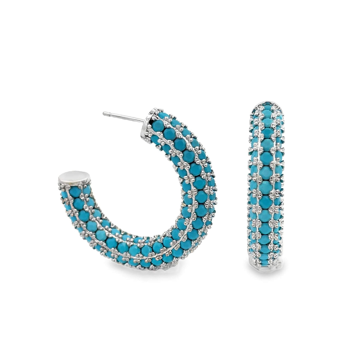A pair of sterling silver hoop earrings encrusted with vibrant turquoise beads sits against a clean white background.