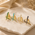 Premium Gold Filled spike huggie earrings featuring brilliant cubic zirconia. Available in Emerald Green, Turquoise, Clear, and Sapphire Blue for a modern everyday look.
