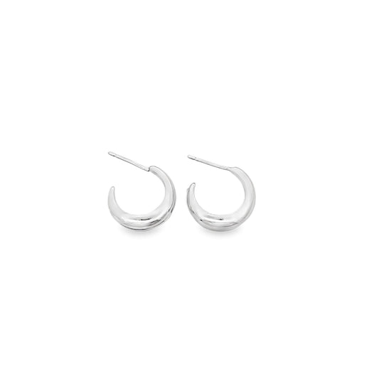 A pair of polished silver chunky hoop earrings rests against a clean white background.