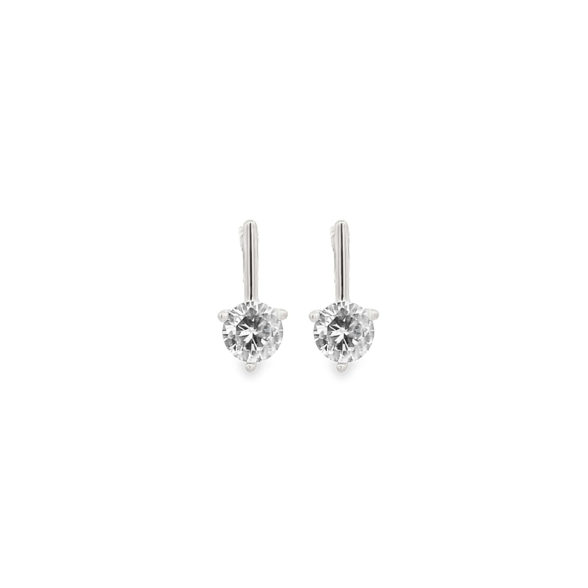 A pair of elegant white gold diamond drop earrings sparkles against a clean white background.