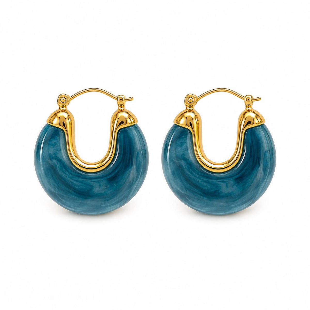 A pair of gold-accented blue resin hoop earrings rests against a clean white background.