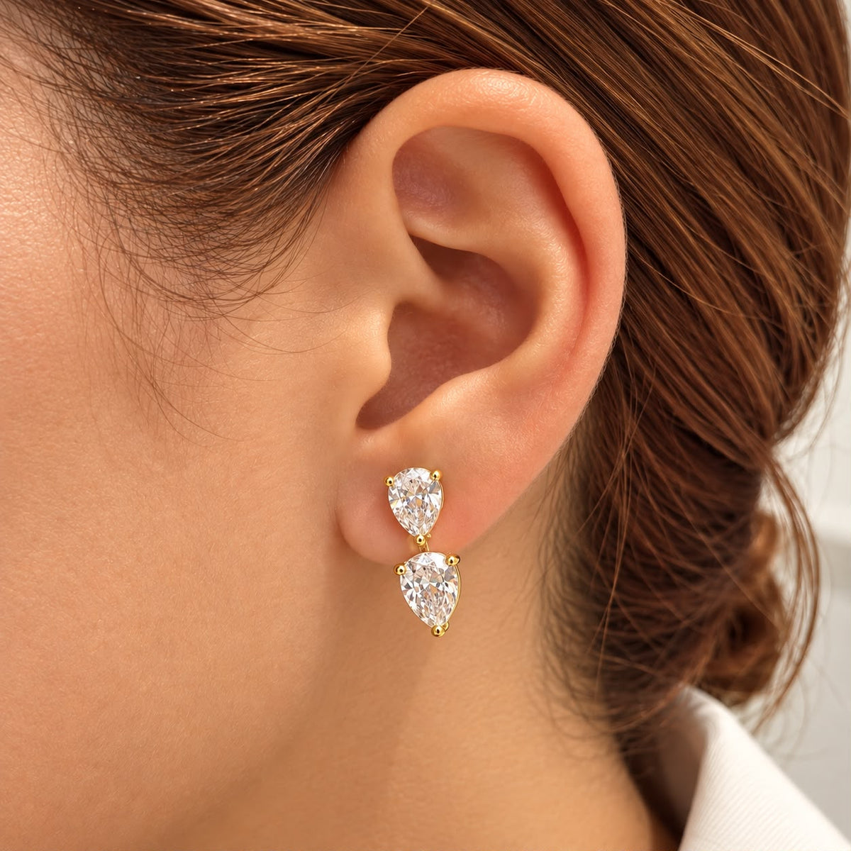 Elegant pear cut double drop earrings featuring two faceted stones in a refined 18K Gold Filled setting. Available in multiple color options.