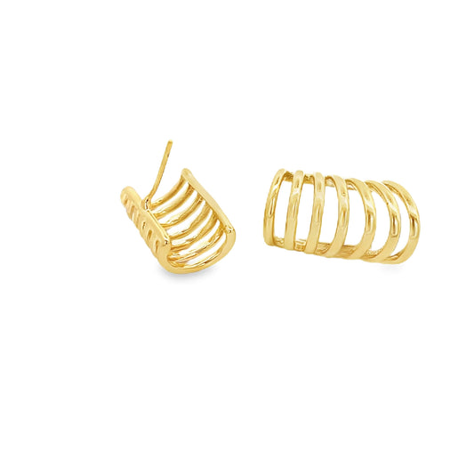 A pair of gold multi-band huggie earrings rests against a clean white background.