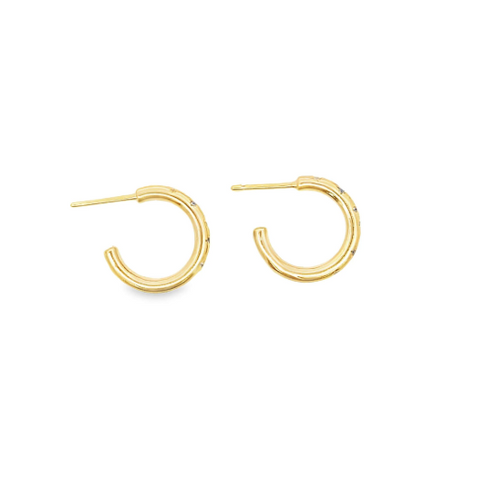 A pair of gold hoop earrings with delicate diamond accents lie flat against a white background.
