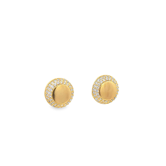A pair of gold stud earrings features smooth central discs surrounded by halos of sparkling pave diamonds.
