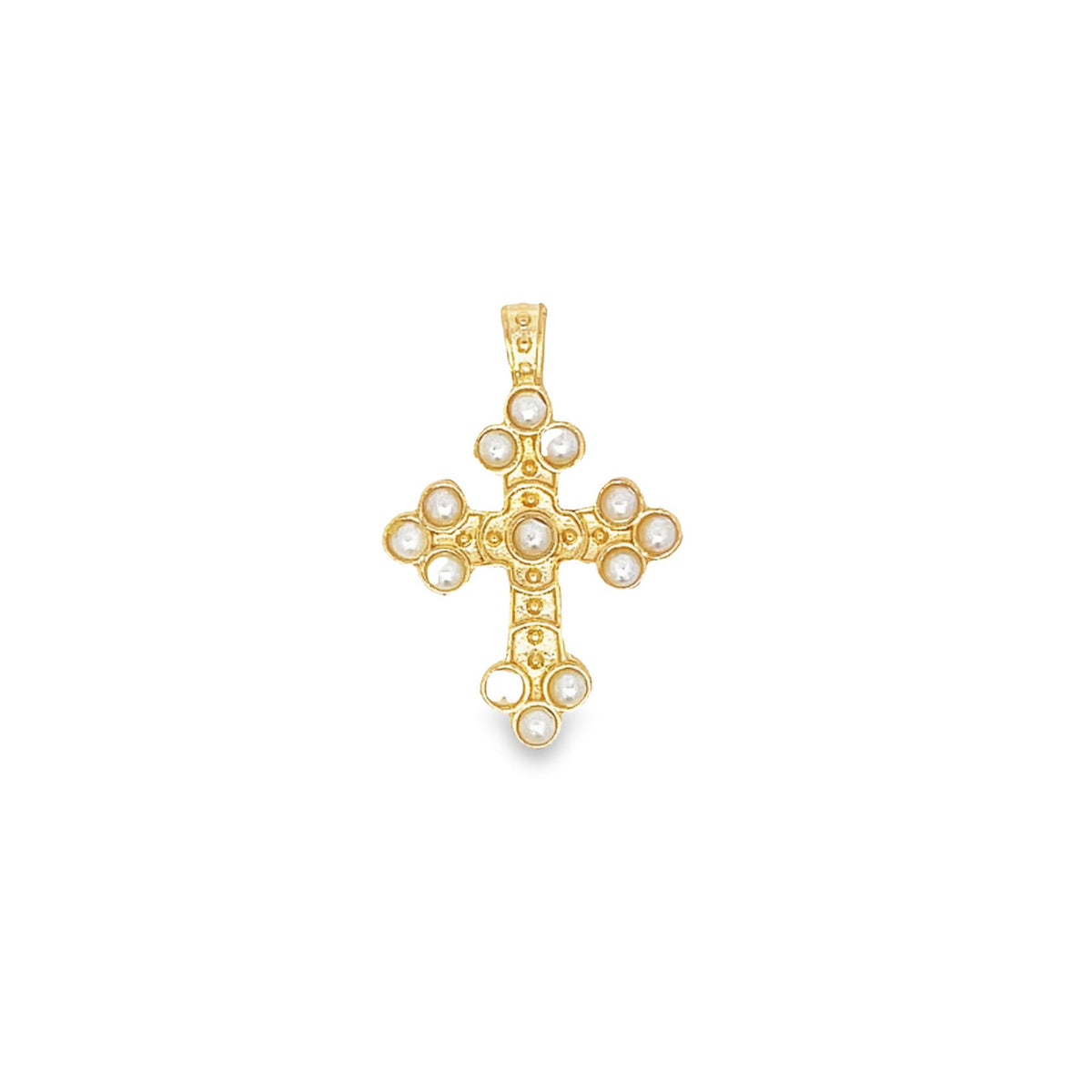 A gold cross pendant features intricate detailing and is adorned with embedded white pearls against a plain white background.