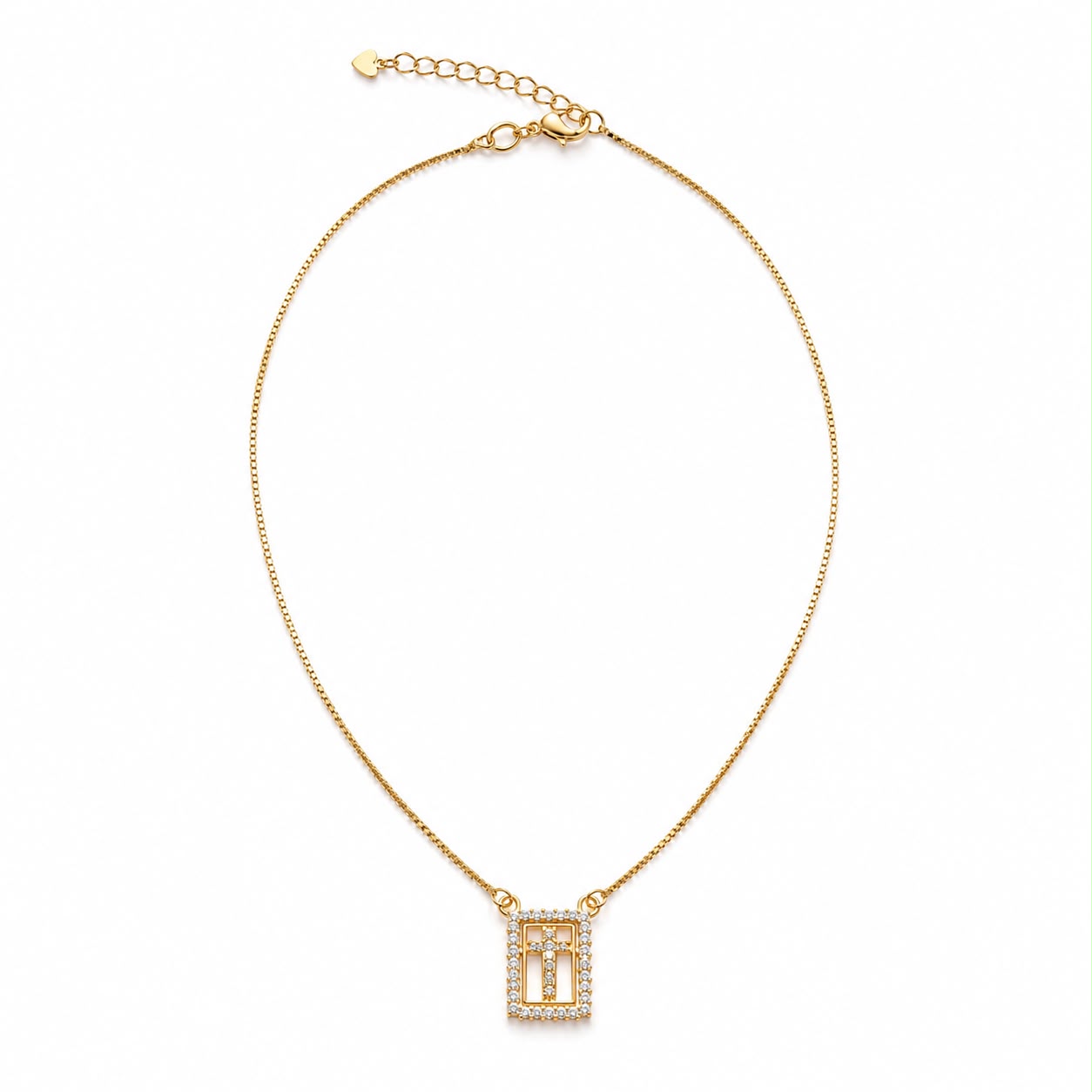 A delicate gold chain necklace displays a rectangular diamond-encrusted cross pendant against a plain white background.