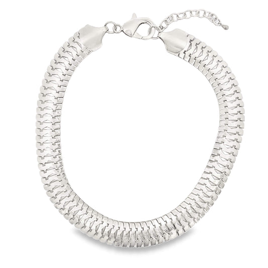 A thick silver herringbone chain necklace features a lobster clasp and an adjustable extension chain.