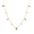 A delicate gold chain necklace dangles multicolored gemstone drops, featuring a central green emerald-cut pendant against a clean white background.