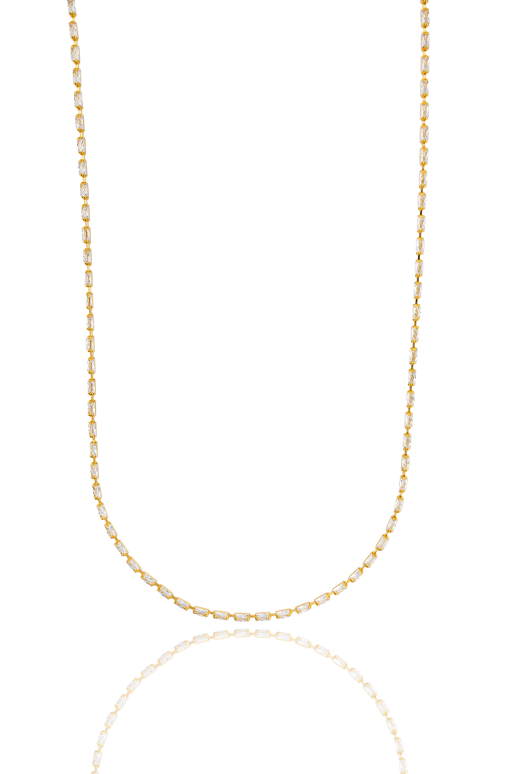A delicate gold necklace set with rectangular baguette crystals sparkles against a plain white background.