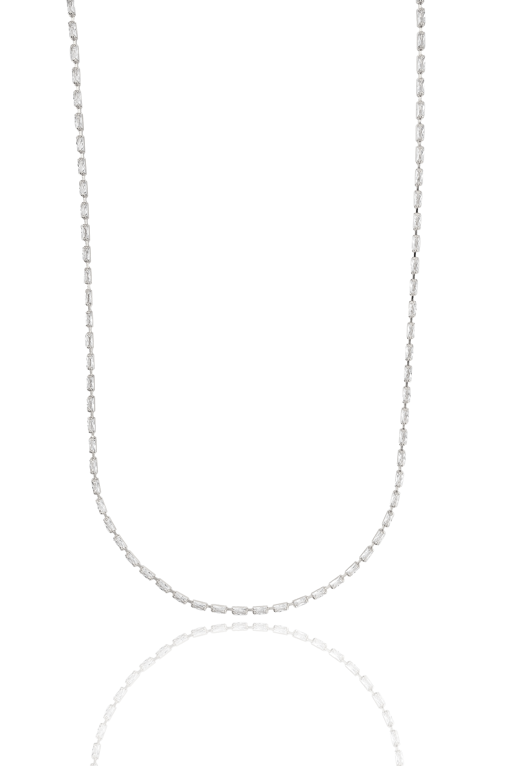A delicate diamond baguette station necklace glimmers against a stark white background.