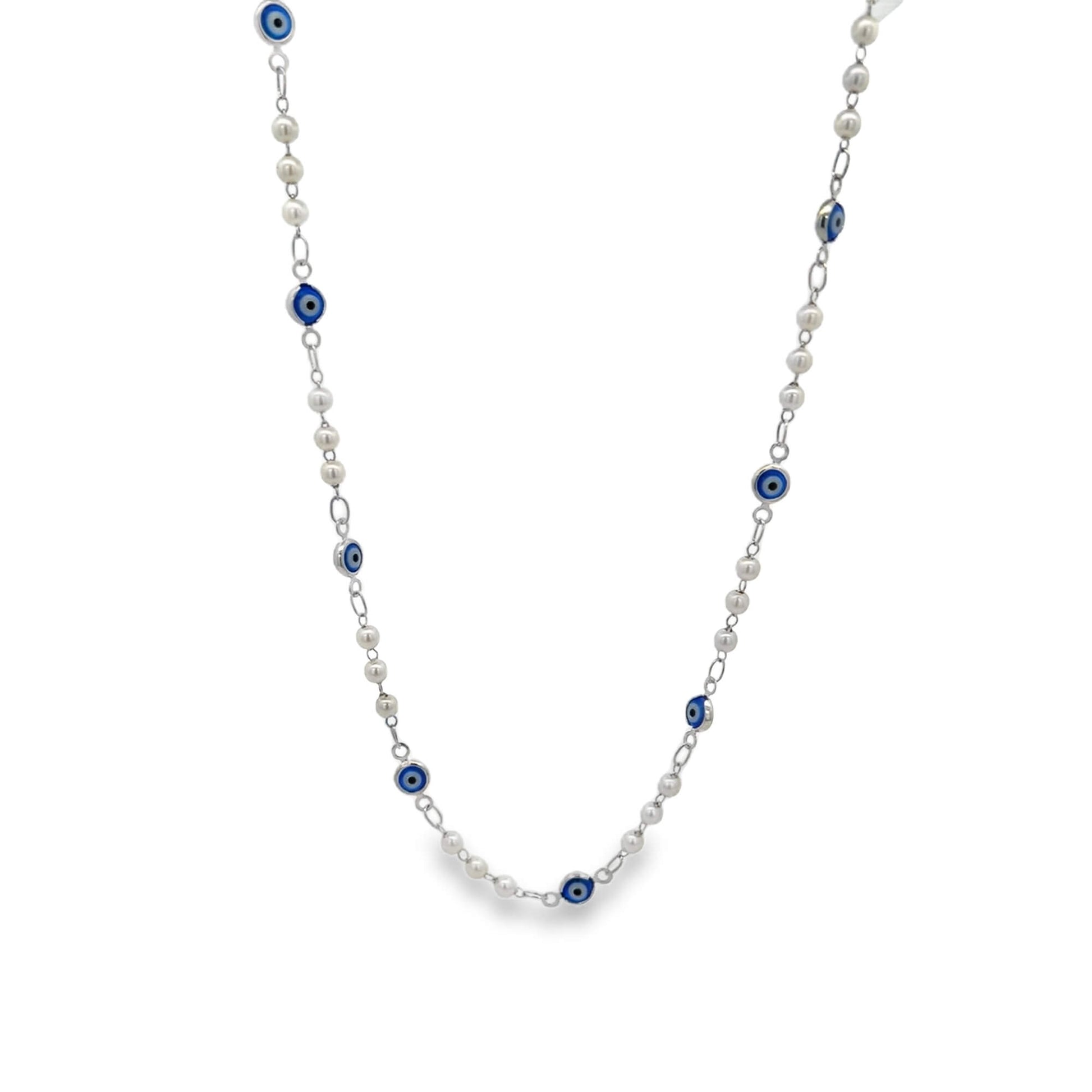 A delicate silver necklace features alternating white pearls and blue evil eye beads against a clean white background.