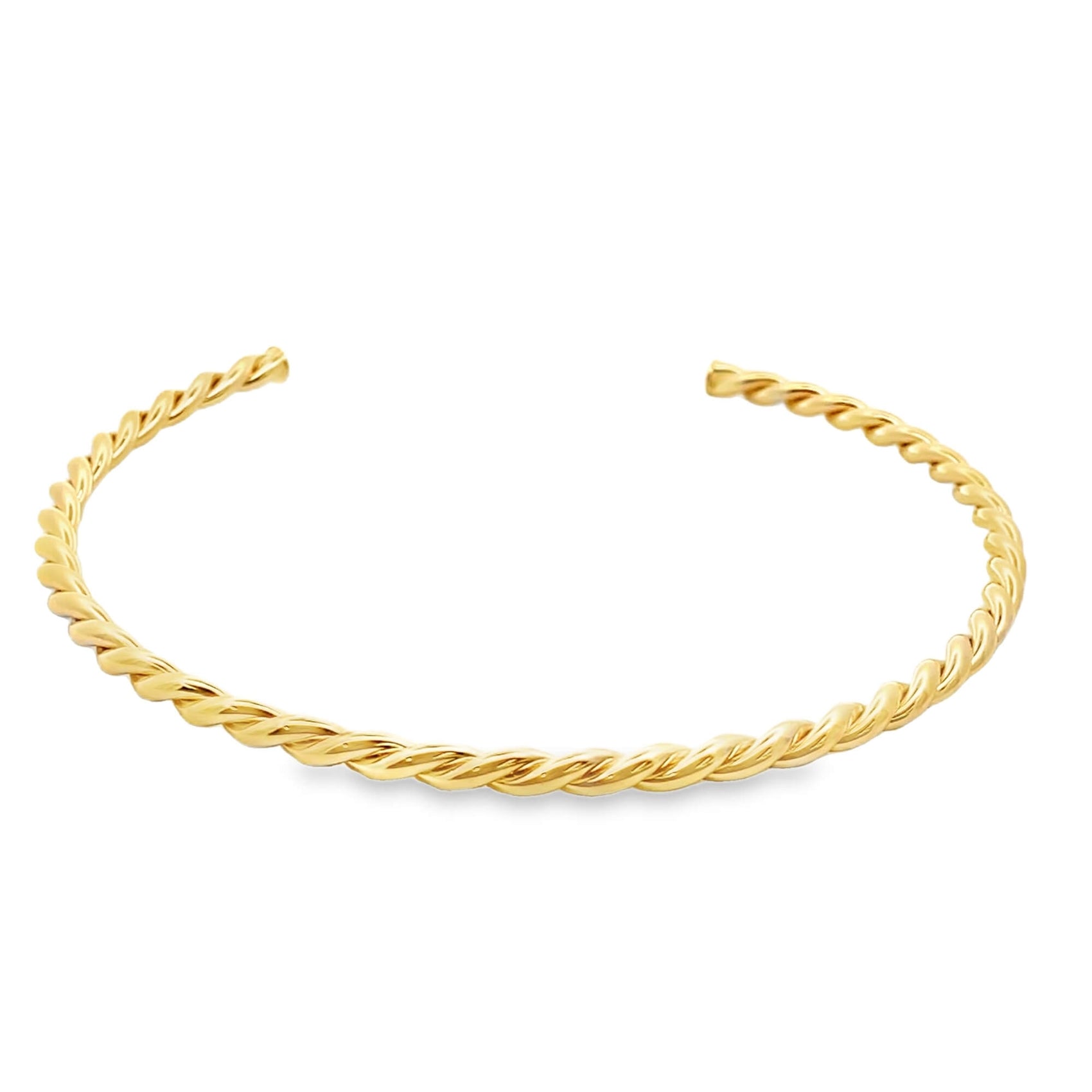 A polished gold cuff bracelet features an elegant twisted rope design against a clean white background.