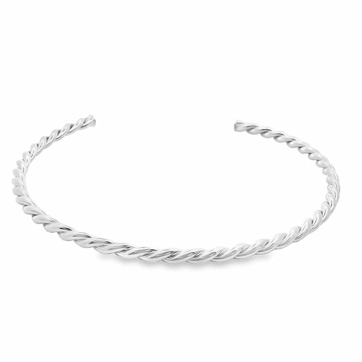 A polished silver twisted cuff bracelet rests against a clean white background.