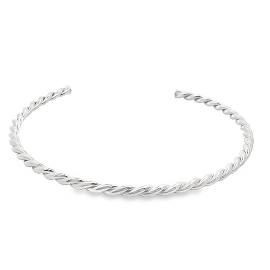 A polished silver twisted cuff bracelet rests against a clean white background.