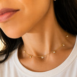 Elegant 14-inch station choker featuring bezel-set Cubic Zirconia stones on a delicate 18K Gold Filled chain. Perfect for layering or everyday wear.