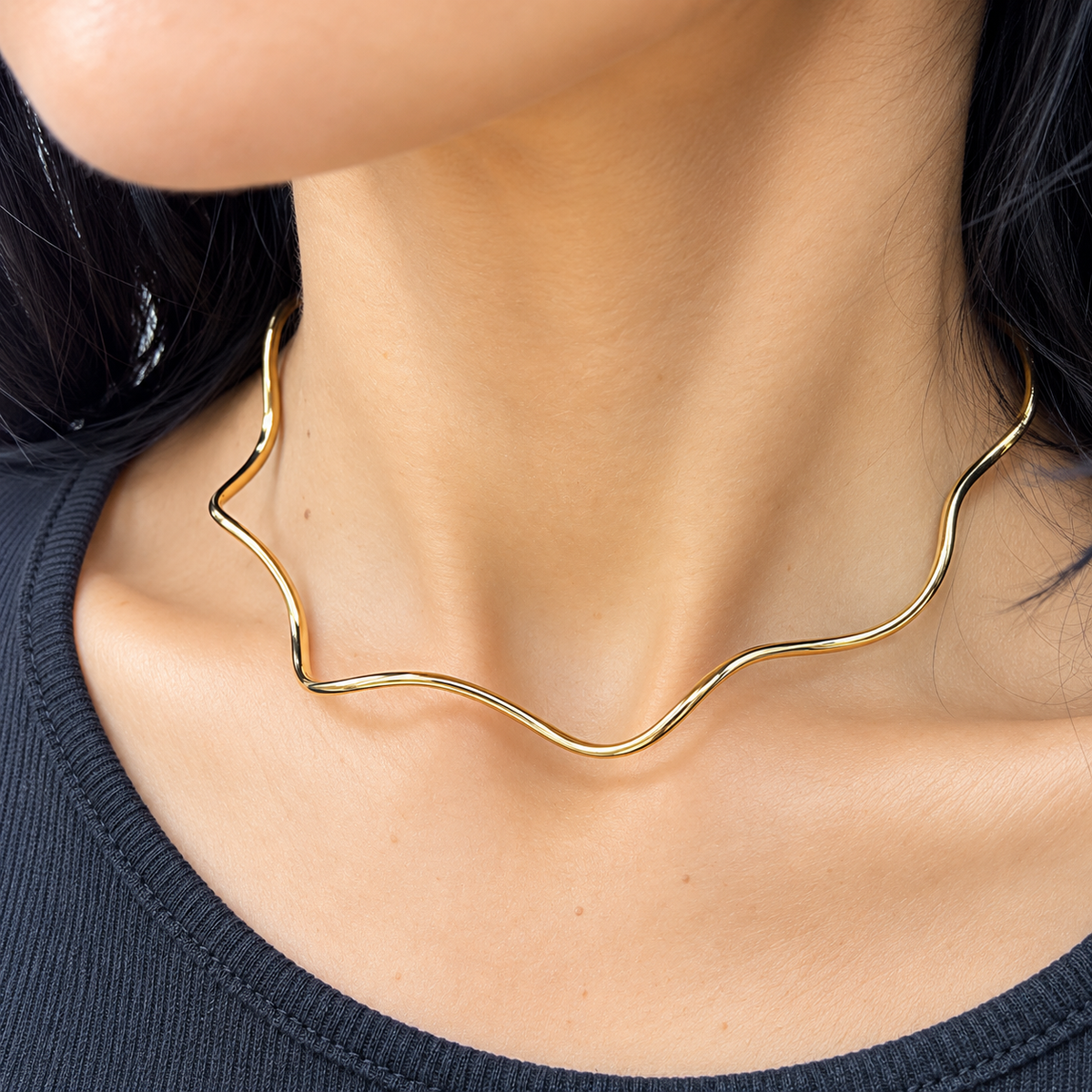 Shop the Wavy Sculptural Choker Necklace with an organic, fluid silhouette and polished finish. Available in 18K Gold Filled and Rhodium Filled.