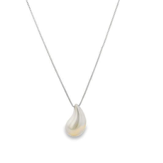 A delicate silver teardrop pendant hangs gracefully from a matching chain necklace.