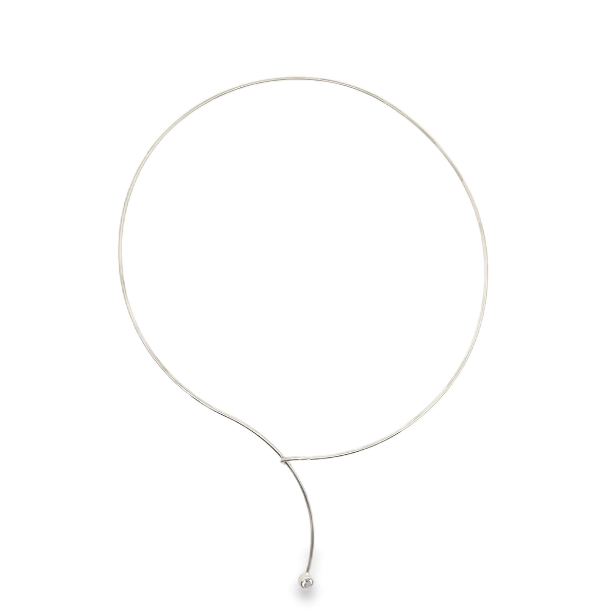 A delicate silver wire choker necklace features a graceful dangling drop accented with a single sparkling stone.