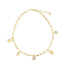 A gold paperclip chain necklace features dangling charms shaped like a house, lock, leaves, and a flower, all embellished with sparkling crystals against a clean white background.