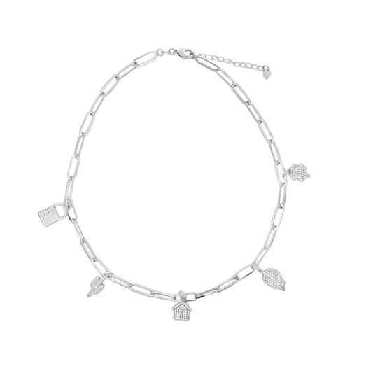 A silver paperclip chain necklace displays charming diamond-encrusted charms shaped like a house, lock, leaf, and cactus.