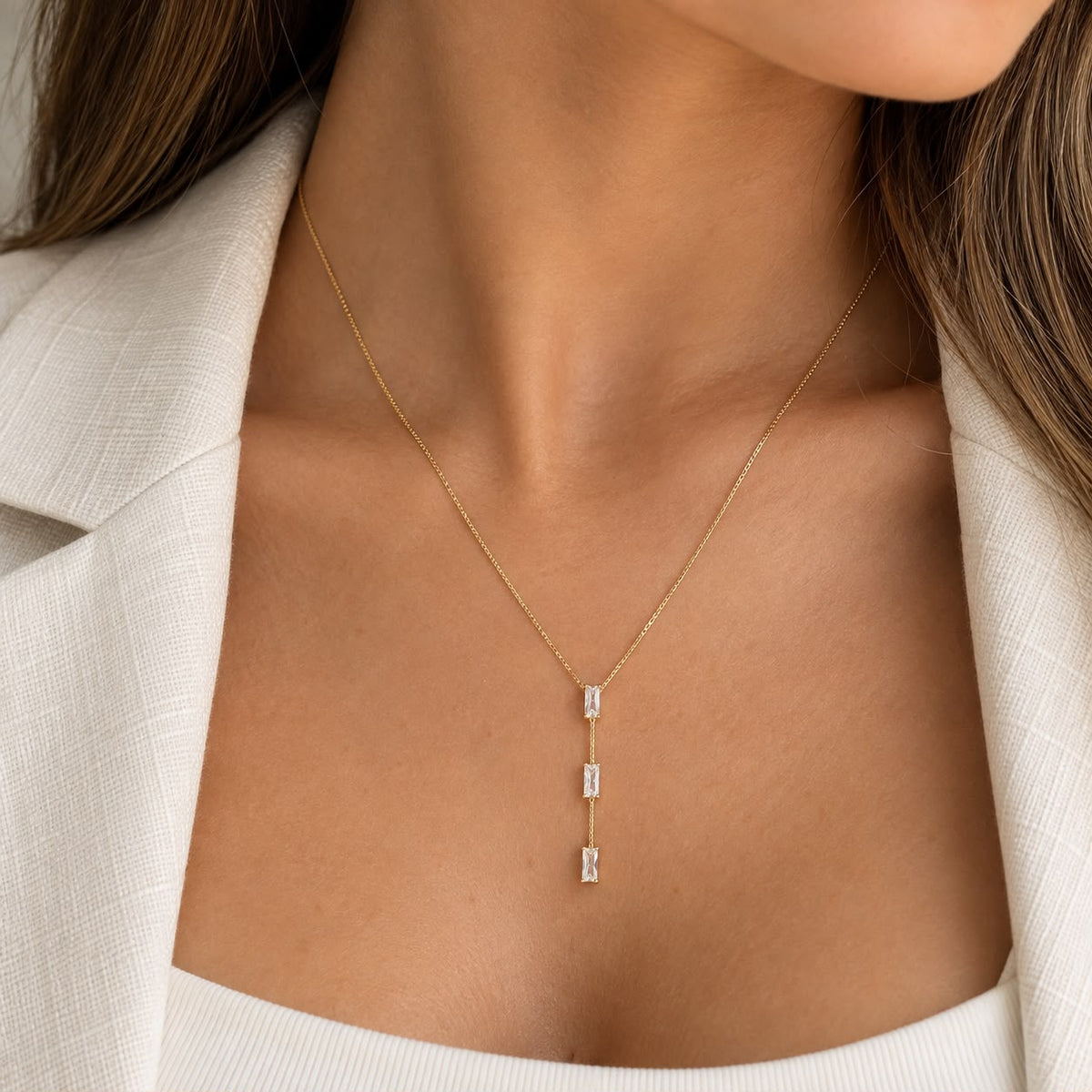 Shop the Triple Baguette CZ Y-Lariat Necklace featuring three baguette-cut CZ stones in an elegant linear Y-shaped drop design.