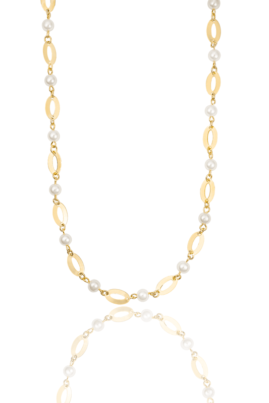A gold and pearl station necklace features alternating oval links and lustrous white pearls on a reflective white surface.