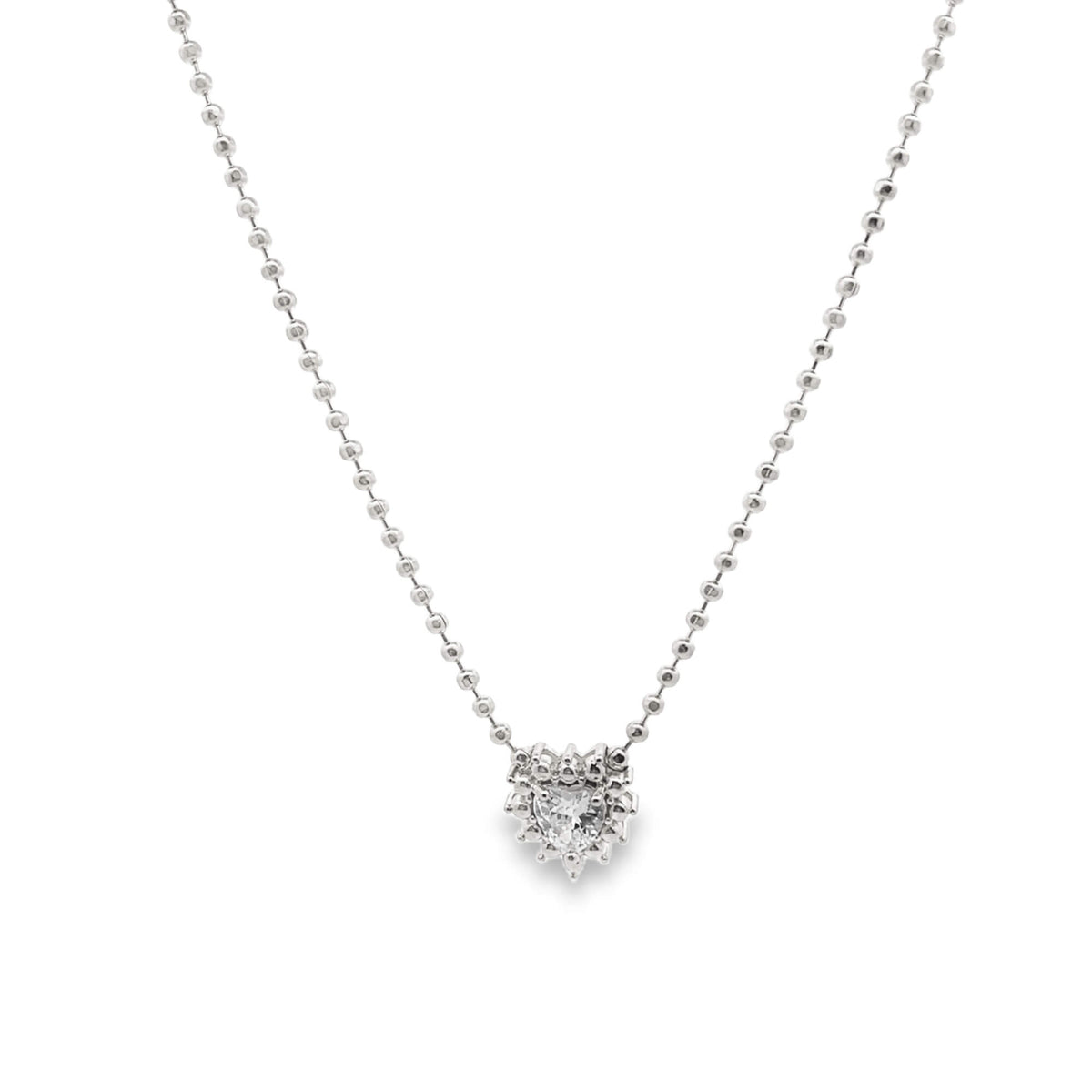 A delicate silver ball chain necklace features a sparkling heart-shaped diamond pendant suspended against a clean white background.