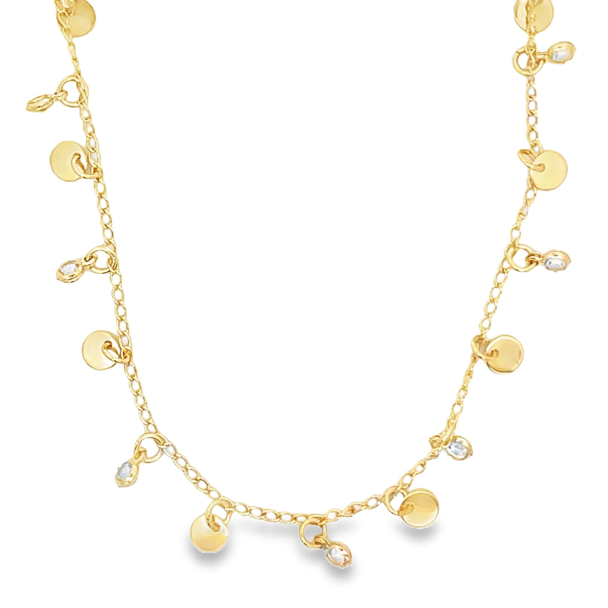 A delicate gold charm necklace features alternating coin-shaped pendants and sparkling crystal drops along its chain against a white background.