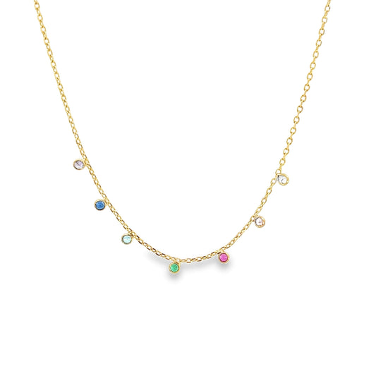 A delicate gold chain necklace dangles multicolored bezel-set gemstone charms against a clean white background.