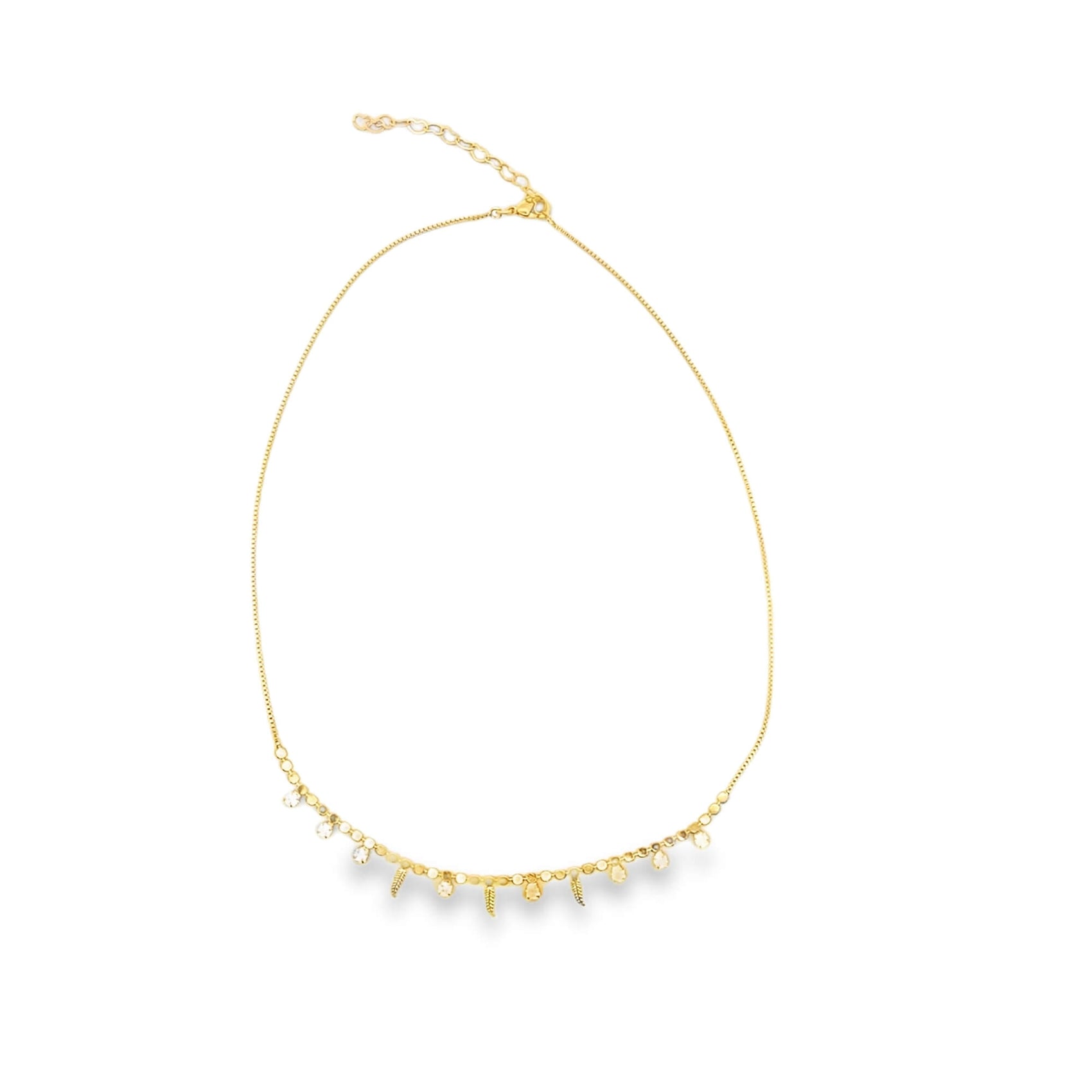 A delicate gold chain necklace dangles charms and sparkling gemstones against a plain white background.