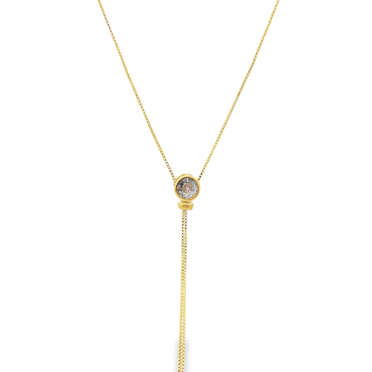 A delicate gold lariat necklace features a sparkling bezel-set diamond pendant hanging against a plain white background.