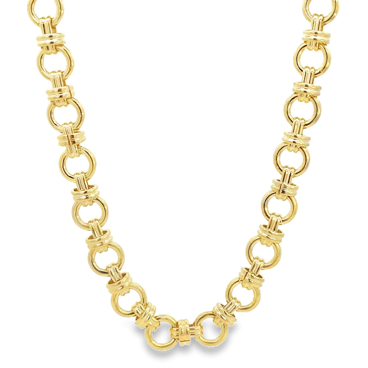 A polished gold link necklace gleams against a plain white background, showcasing its intricate geometric design.