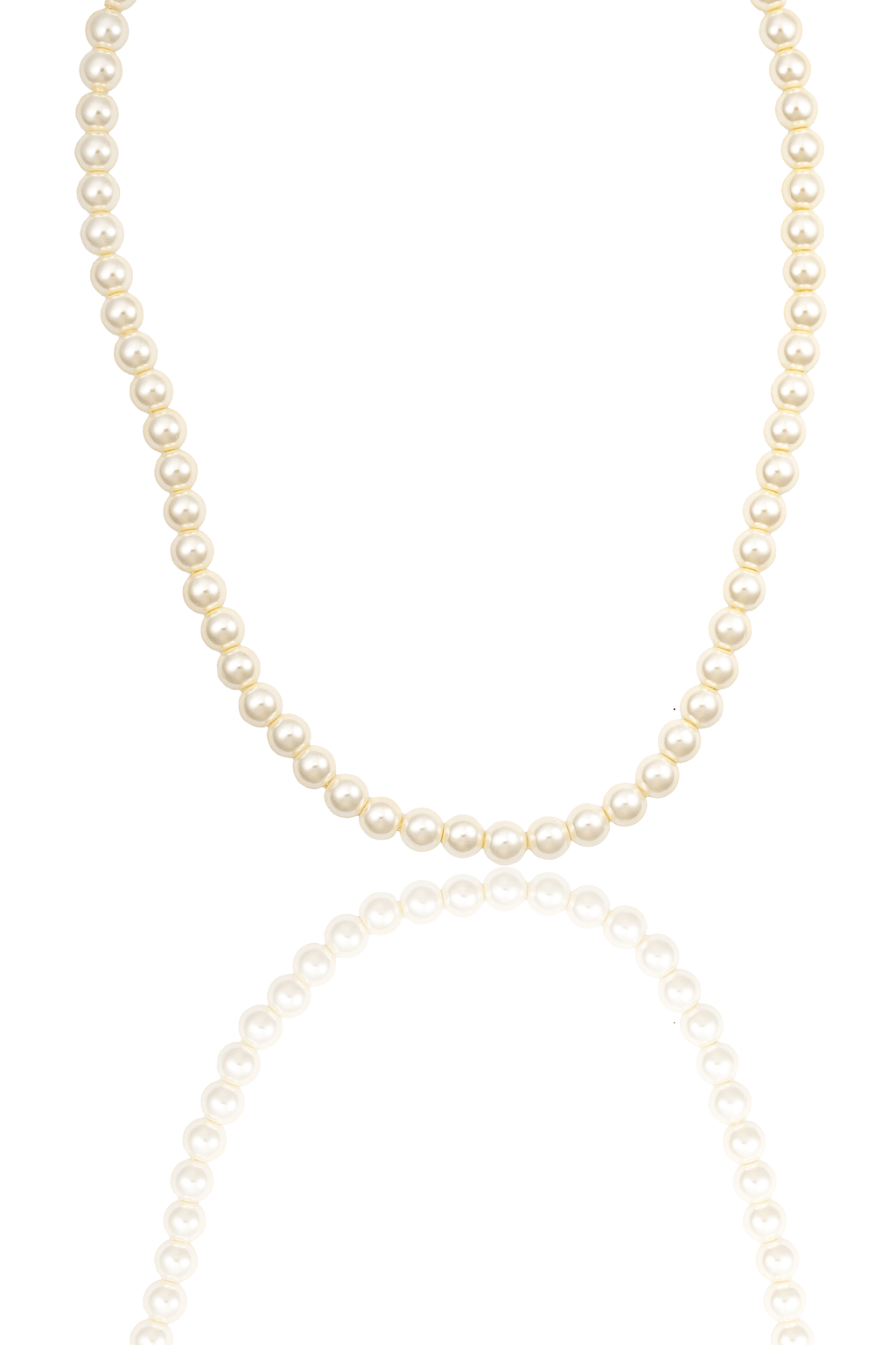 A classic white pearl necklace rests against a clean white background, casting a soft reflection below.