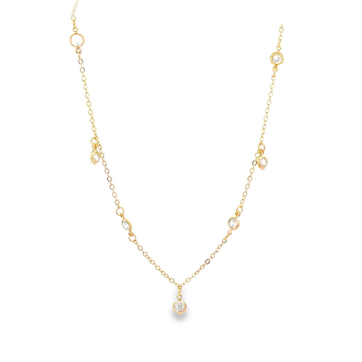 A delicate gold chain necklace sparkles with multiple bezel-set diamond station charms against a clean white background.