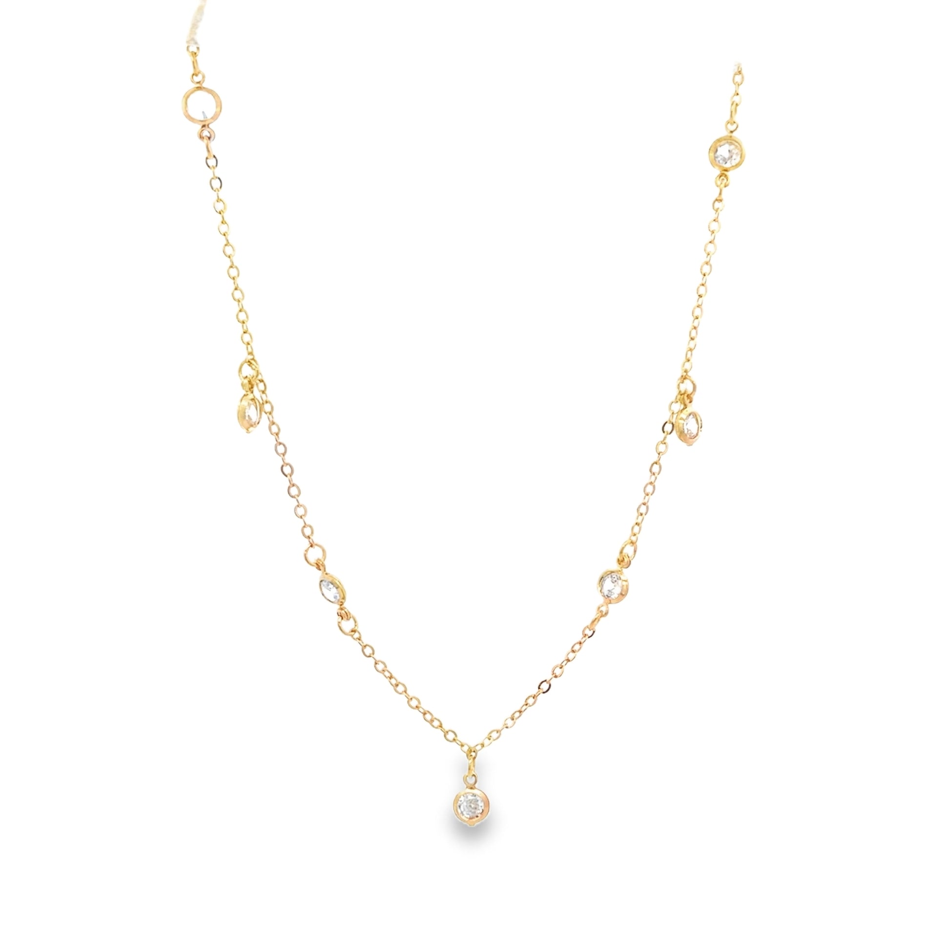 A delicate gold chain necklace sparkles with multiple bezel-set diamond station charms against a clean white background.