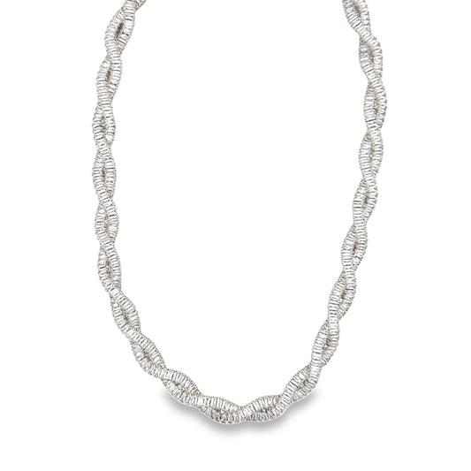 A sparkling diamond tennis necklace features a unique, twisted rope design in white gold.