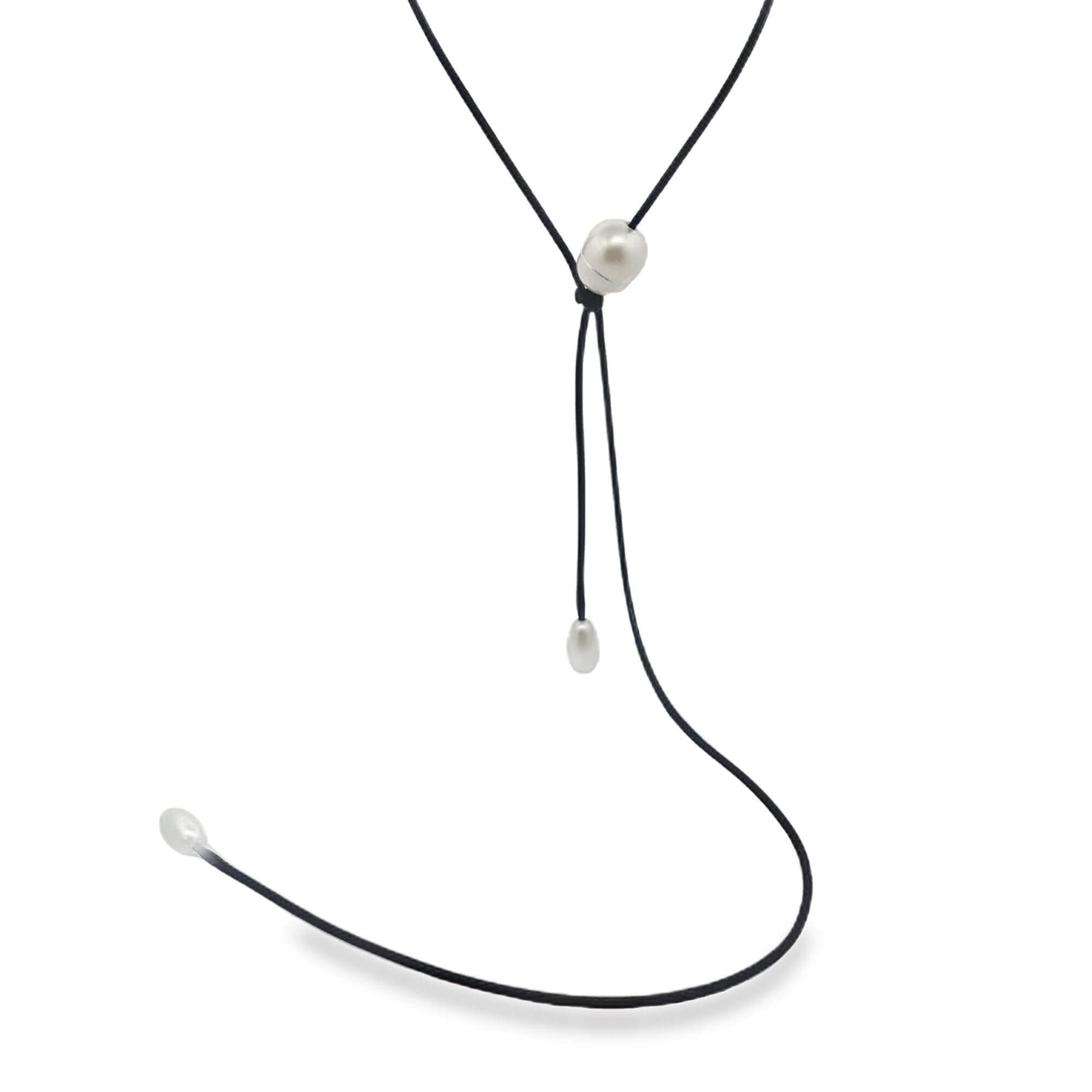 A delicate black cord necklace features three lustrous white pearls set against a clean white background.
