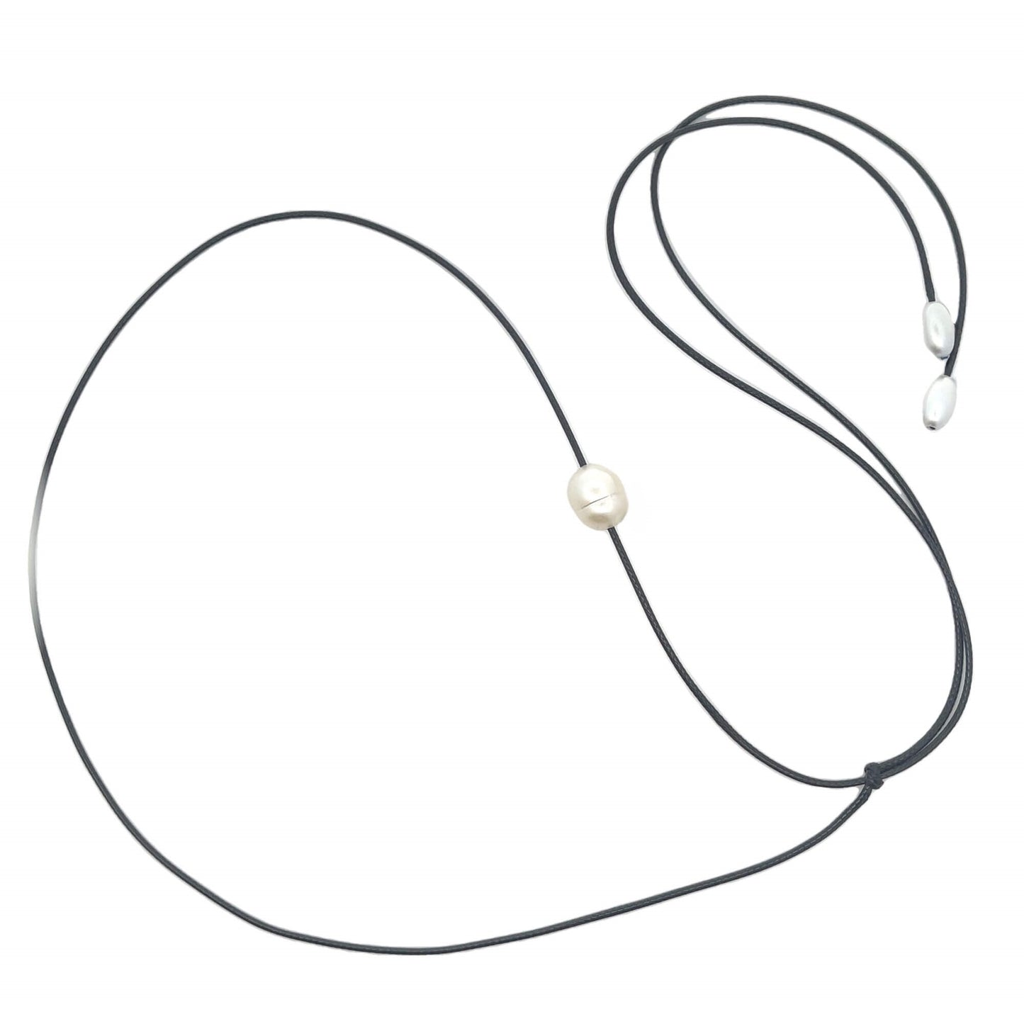 A single white baroque pearl hangs delicately on a black cord necklace against a clean white background.