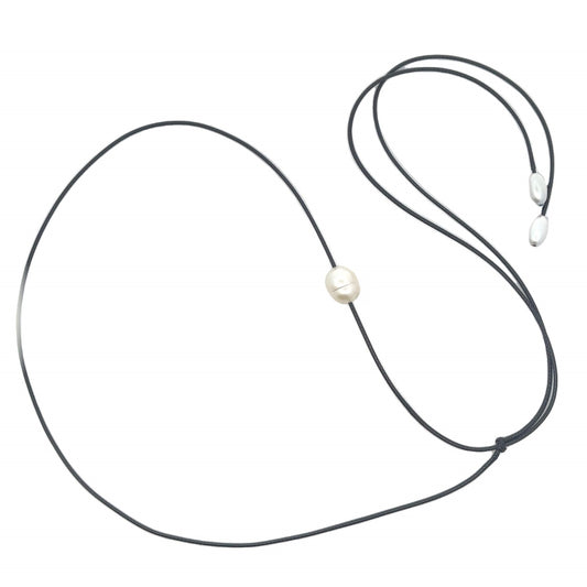 A single white baroque pearl hangs delicately on a black cord necklace against a clean white background.