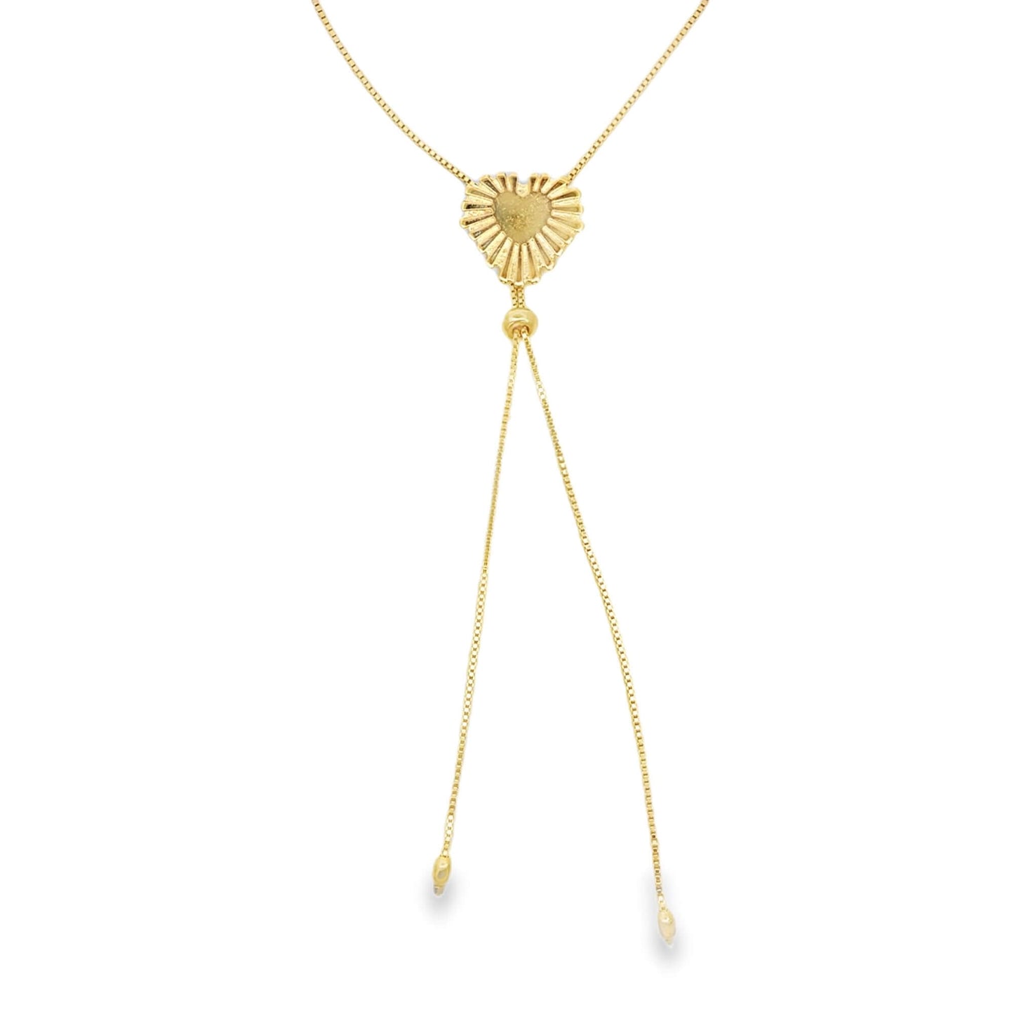 A delicate gold lariat necklace features a textured, sunburst-patterned heart pendant suspended on a fine chain against a white background.