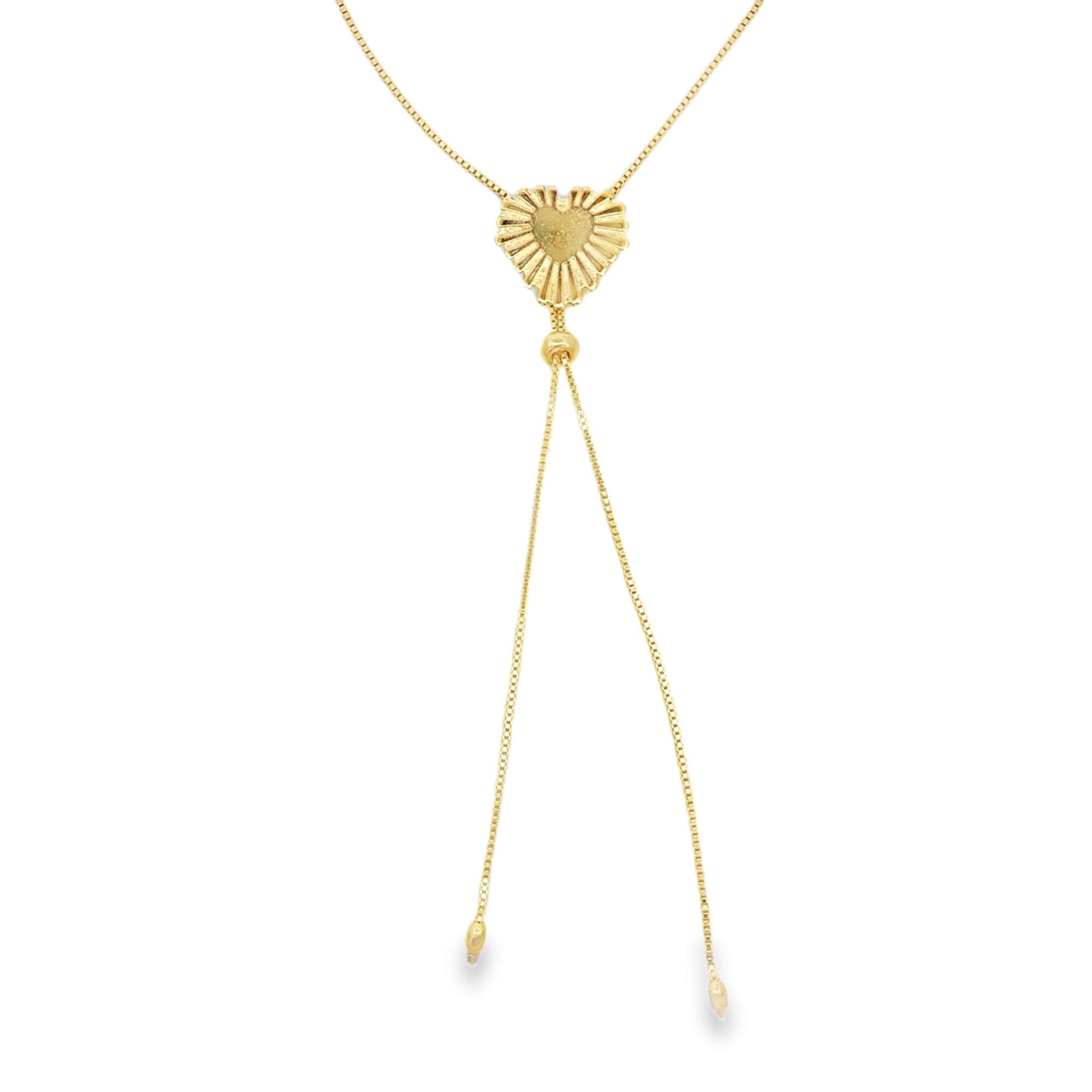A delicate gold lariat necklace features a textured, sunburst-patterned heart pendant suspended on a fine chain against a white background.