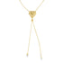 A delicate gold lariat necklace features a textured, sunburst-patterned heart pendant suspended on a fine chain against a white background.