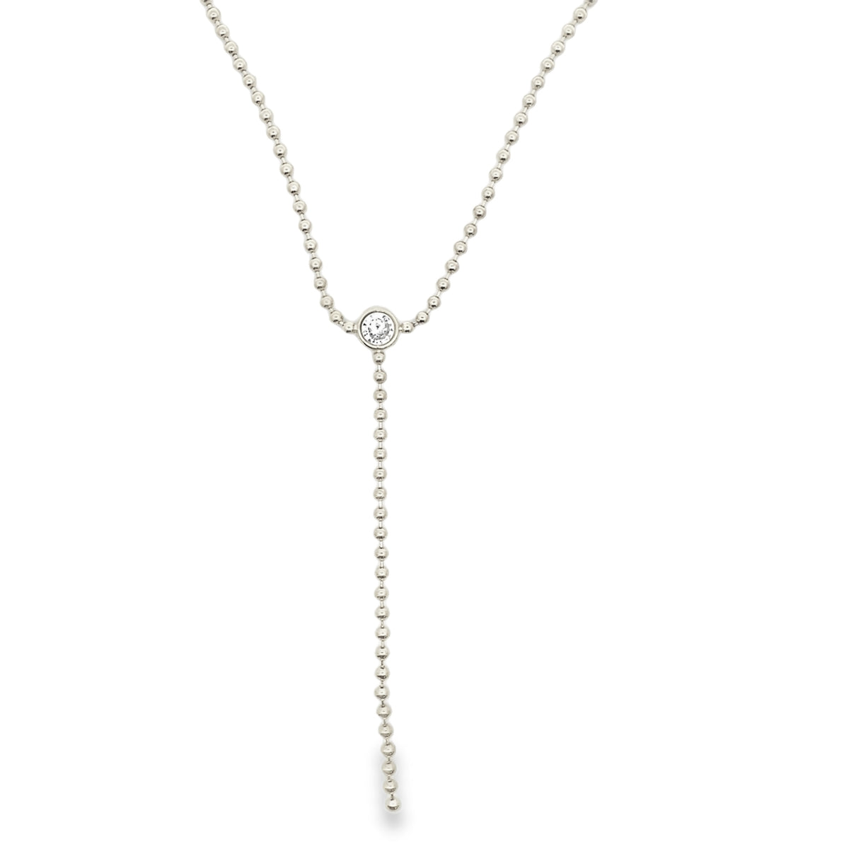 A delicate silver lariat necklace features a beaded chain and a sparkling bezel-set diamond pendant.